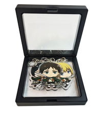 Load image into Gallery viewer, Cool set of Attack On Titan keychains. Premium design DTG quality acrylic keyrings. The main acrylic panel stands at 6cm (approx), and 4mm (approx) thickness. 3 piece set and packaged in a cute see-through pouch. Keychain 1: Armin Arlert Keychain 2: Eren Yeager Keychain 3: Mikasa Ackerman